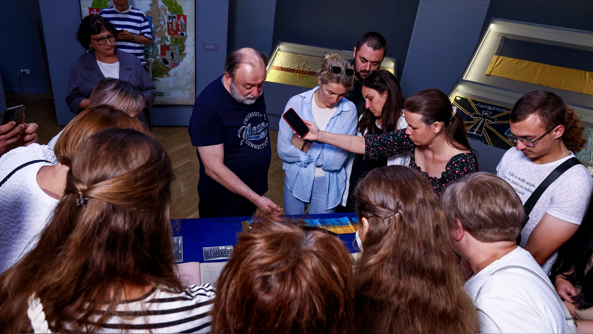 Oleksandr Kucheruk and history teachers examine unique museum items related to Yevhen Konovalets