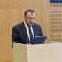 Василь Боднар виступає з трибуни на конференції, читає промову з блокнота
